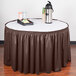 A table with a brown Snap Drape table skirt.