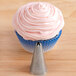 A cupcake with pink frosting piped with an Ateco closed star piping tip.