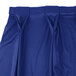 A royal blue Snap Drape Wyndham bow tie pleat table skirt with Velcro clips.