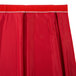 A red table skirt with a white box pleat band.