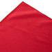 A red box pleat table skirt with a corner.