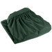 A folded jade green Snap Drape table skirt with shirred pleats.