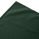 A dark green Jade Snap Drape table skirt with a folded edge.