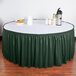 A table with a Snap Drape Wyndham jade table skirt.