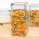 A group of Anchor Hocking square glass jars filled with spiral pasta.