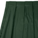 A dark green Snap Drape Wyndham box pleat table skirt.