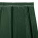 A green table skirt with a white box pleat.