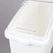 A white plastic container with a sliding/flip lid.