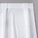 A white Snap Drape table skirt with continuous pleats.