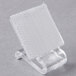 A clear plastic clip with a white square on a clear plastic holder.