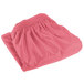 A dusty rose shirred pleat table skirt on a white background.