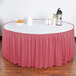 A table with a dusty rose Snap Drape table skirt and velcro clips on it.