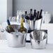 Three American Metalcraft stainless steel beverage tubs filled with ice and wine bottles.