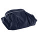 A navy blue Snap Drape table skirt in a bag with a zipper.