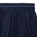 A navy Snap Drape Wyndham table skirt with a white pleated hem.