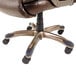 A brown leather Alera office chair with black wheels.