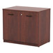 A medium cherry wooden Alera storage cabinet with two doors and two drawers with black handles.