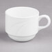 A white Libbey Royal Rideau porcelain stacking cup with a handle on a gray surface.