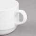 A close-up of a Libbey Royal Rideau white porcelain stacking cup with a handle.