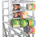 A Winholt aluminum rack filled with #10 and #5 cans of food.