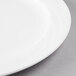 A close-up of a Libbey Royal Rideau white porcelain plate with a medium white rim.