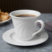 A Libbey Royal Rideau white porcelain tea cup on a saucer.