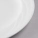 A close-up of a Libbey white porcelain plate with a white rim.