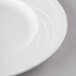 A close-up of a Libbey white porcelain plate with a white rim.