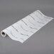A roll of white paper with a wedding pattern in black