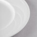 A close-up of a Libbey Elan white porcelain plate with a wide white rim.
