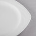 A close up of a Libbey Royal Rideau white porcelain plate with a small white rim.