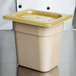 A Cambro 1/8 size amber plastic lid on a food container.