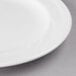 A close-up of a Libbey Royal Rideau white porcelain plate with a white rim.