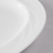 A close-up of a Libbey white porcelain oval platter with a rim.