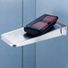 A wallet on a Bobrick stainless steel wall mounted shelf.