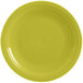 A close-up of a yellow Fiesta® Dinnerware round chop plate with a rim.