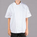 A young woman wearing a white Chef Revival short sleeve chef jacket with mesh back.