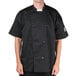 A man wearing a black Chef Revival short sleeve chef jacket with mesh back.
