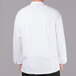 A person wearing a white Chef Revival chef coat with a mesh back.