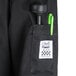 A black Chef Revival long sleeve chef jacket with a green pen in the pocket.