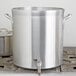 A large silver Vollrath Wear-Ever aluminum stock pot with handles on a stove.