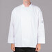 A man wearing a white Chef Revival long sleeve chef jacket with mesh back.