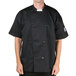 A man wearing a black Chef Revival chef coat with mesh on the back.