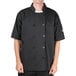 A man wearing a black Chef Revival short sleeve chef coat.