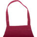 A burgundy Chef Revival bib apron on a counter.