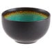 A black stoneware bowl with a green rim.
