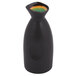 A black Libbey stoneware sake bottle with yellow and green liquid inside.