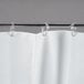 A white Bobrick shower curtain with rings attached.