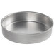 A close-up of a round silver Vollrath Wear-Ever cake pan.