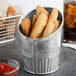 A galvanized metal French fry cup filled with fries on a white background.